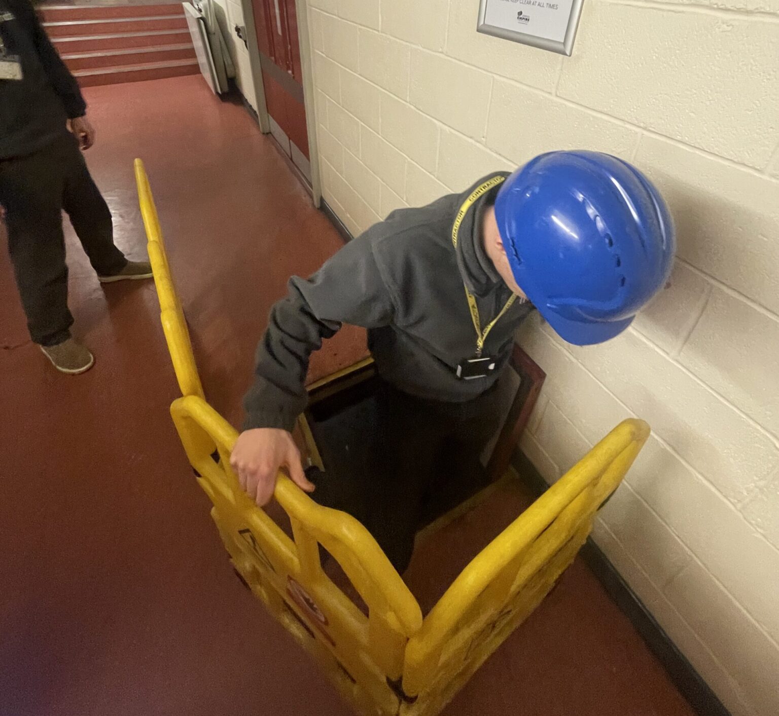 Building Surveyor going down a hatch on a survey.